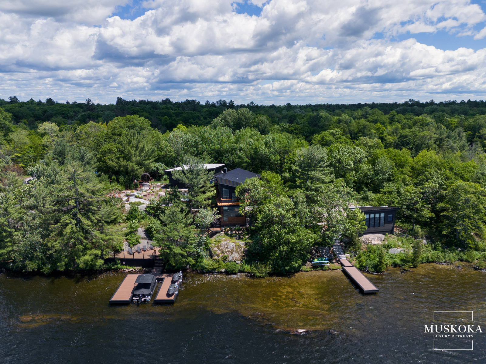 House on a lake surrounded by trees 