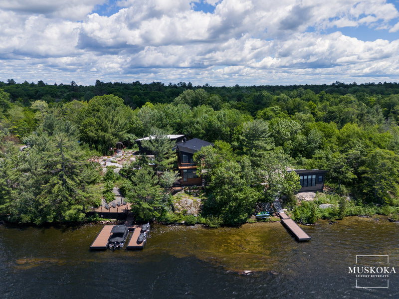 House on a lake surrounded by trees 
