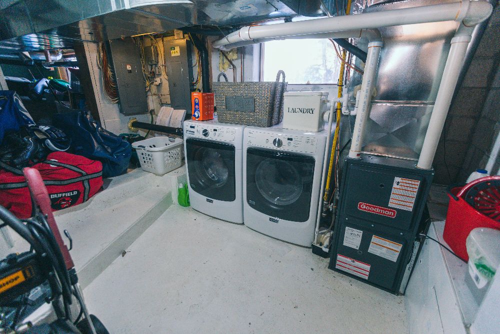 Washing machines in a compact storage area with various items around