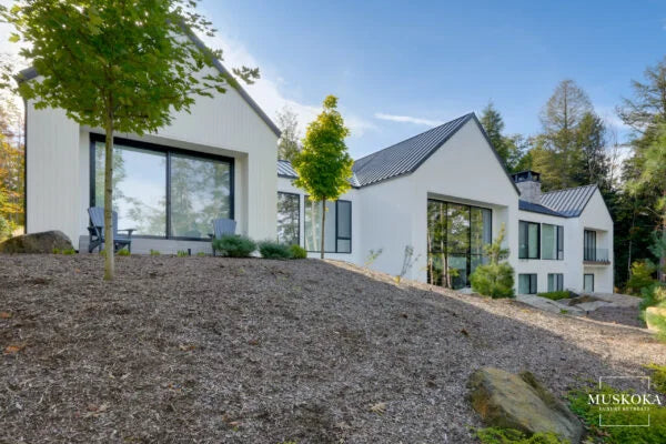 Modern white house with black roof in a suburban setting